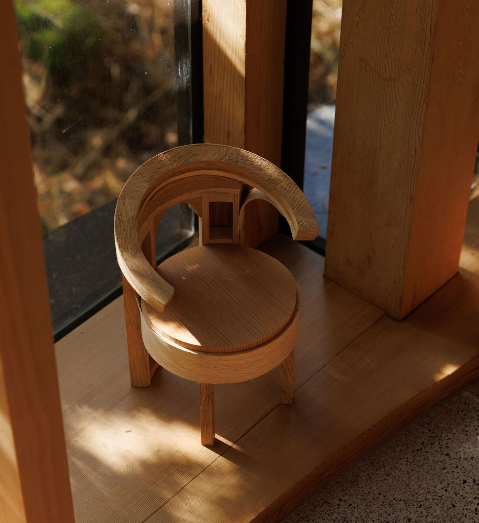 A small wooden model of a dining chair
