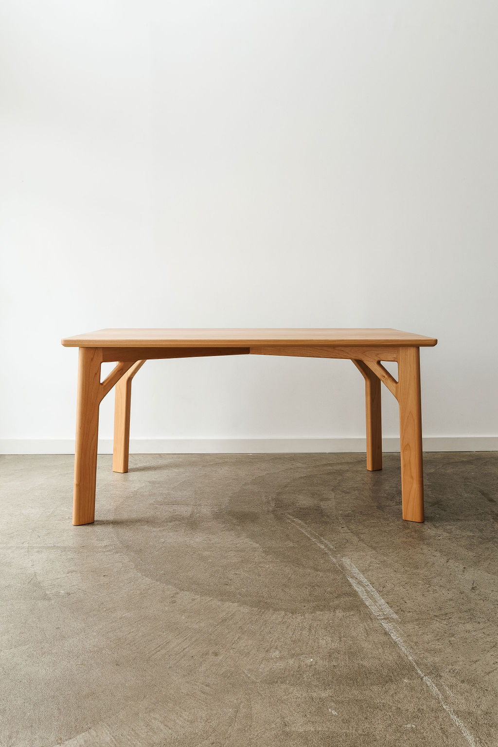 A handmade modern minimal table in a light wood material.
