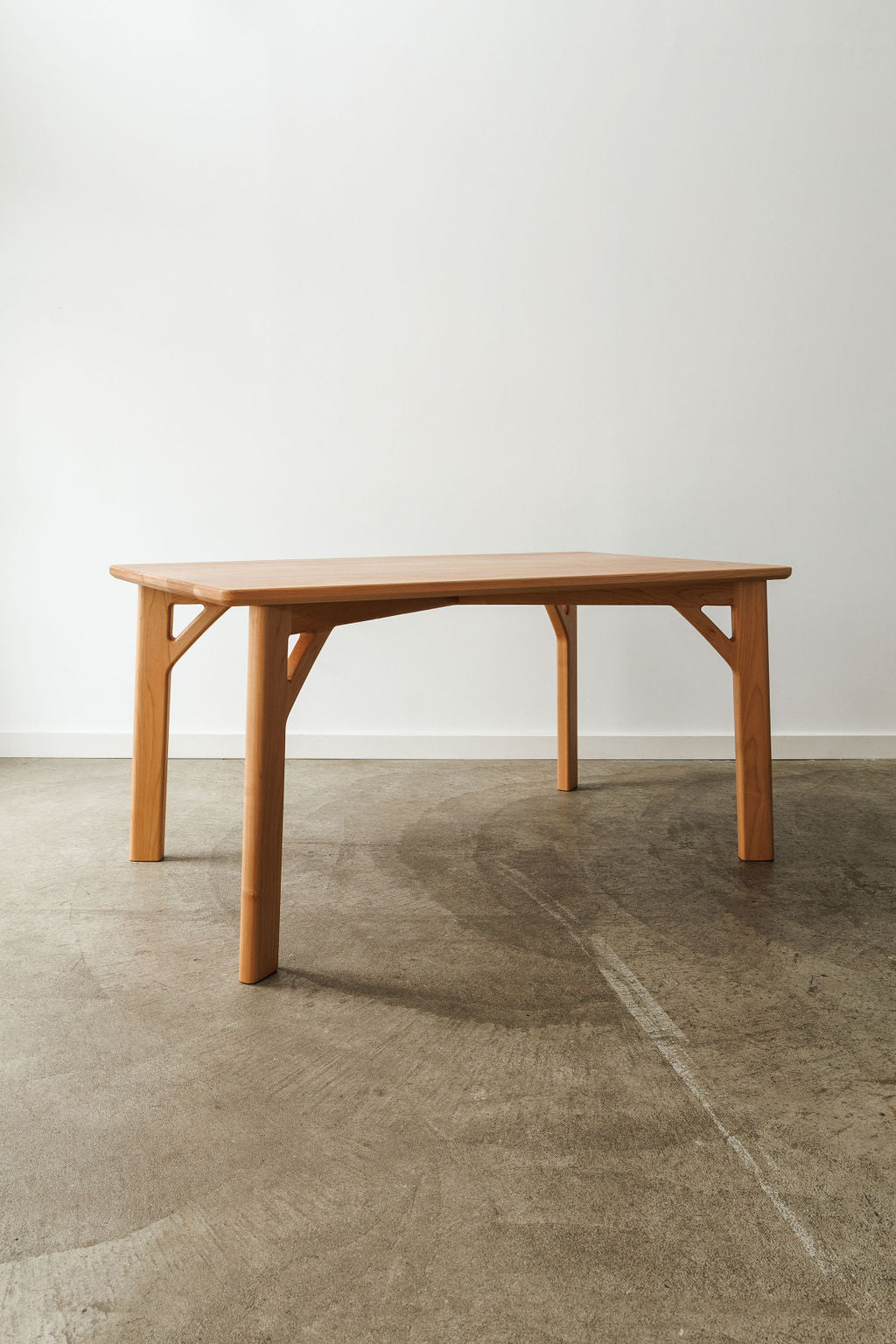 A handmade modern minimal table in a light wood material.