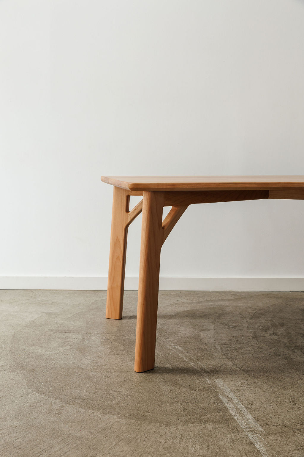 A handmade modern minimal table in a light wood material.